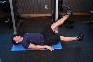 Man with prostatitis does an exercise in the gym